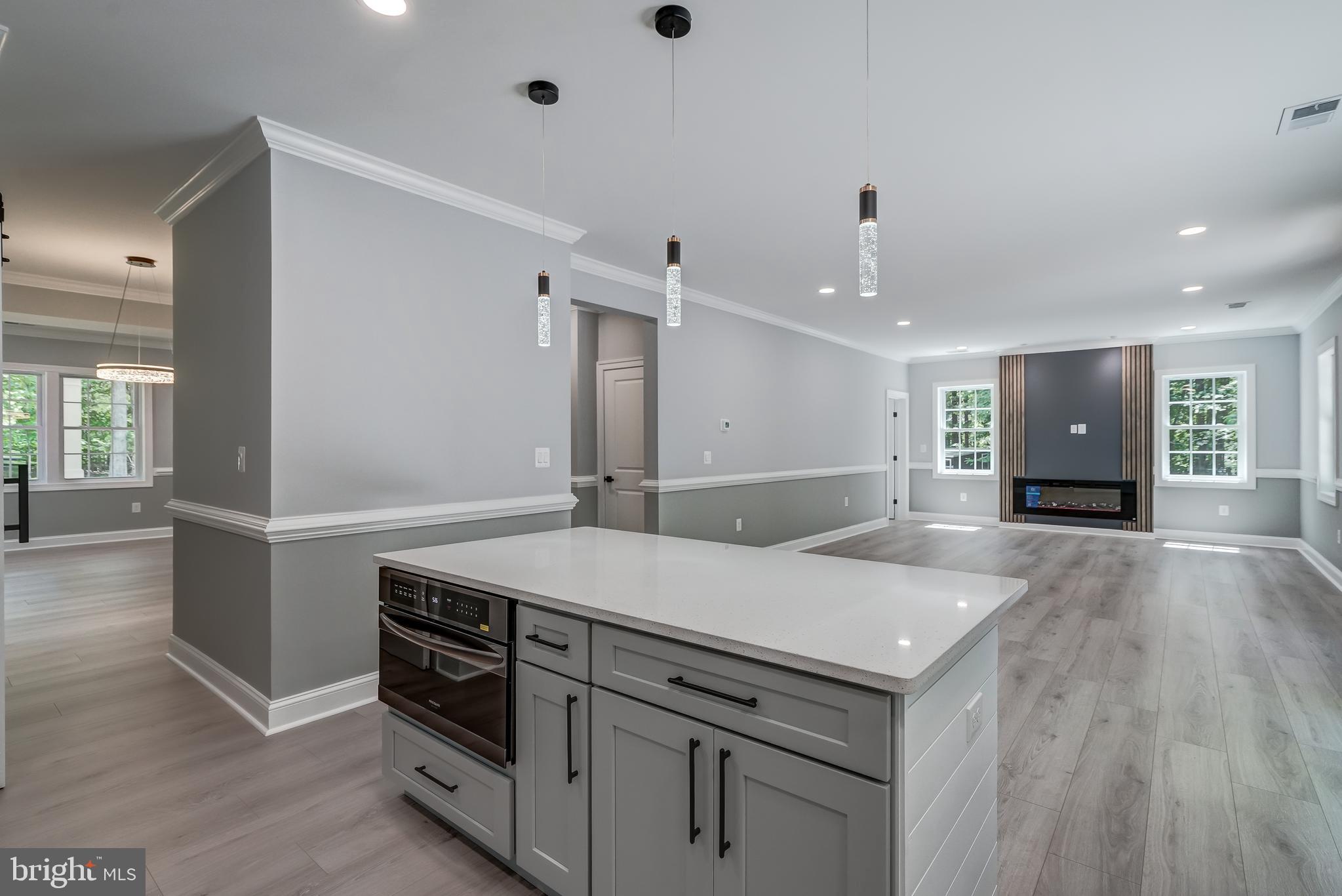 50 Retriever Court Bumpass, VA 23024 - Photo 35 of 77 a view of a kitchen island a sink wooden floor and a living room
