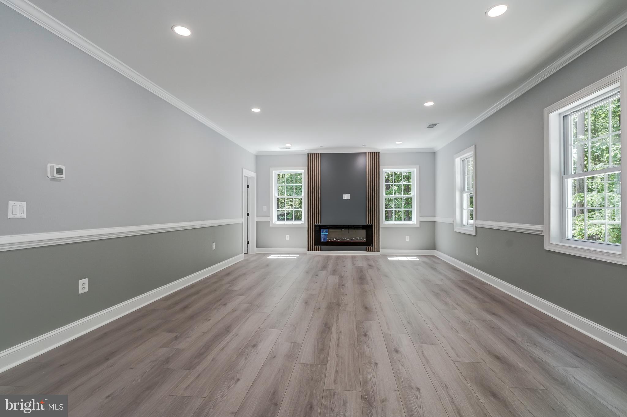50 Retriever Court Bumpass, VA 23024 - Photo 36 of 77 an empty room with wooden floor and windows