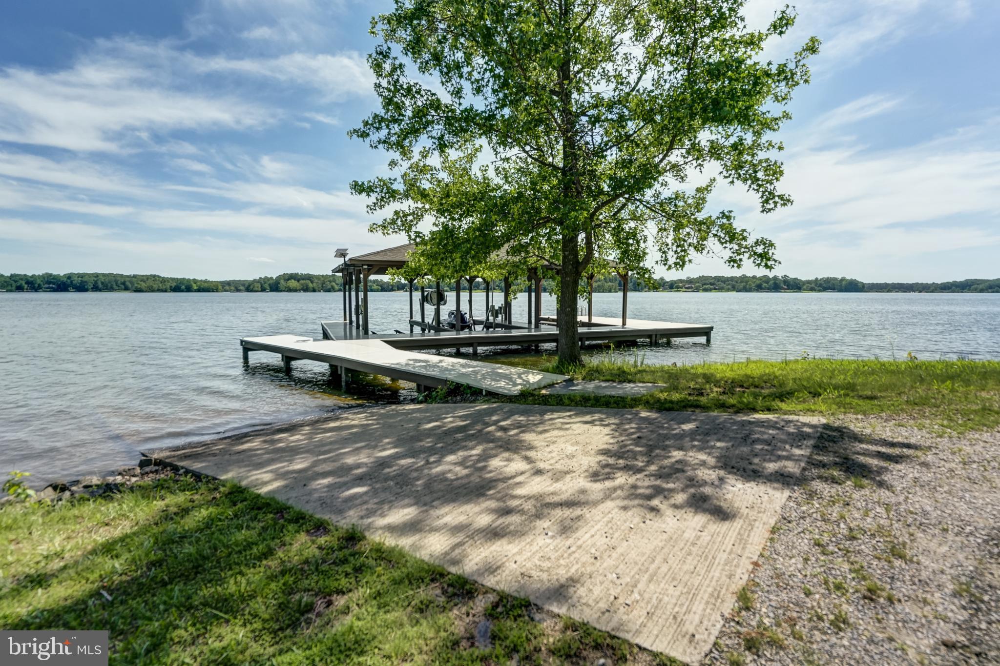 50 Retriever Court Bumpass, VA 23024 - Photo 4 of 77 a view of a lake with beach and trees in the background