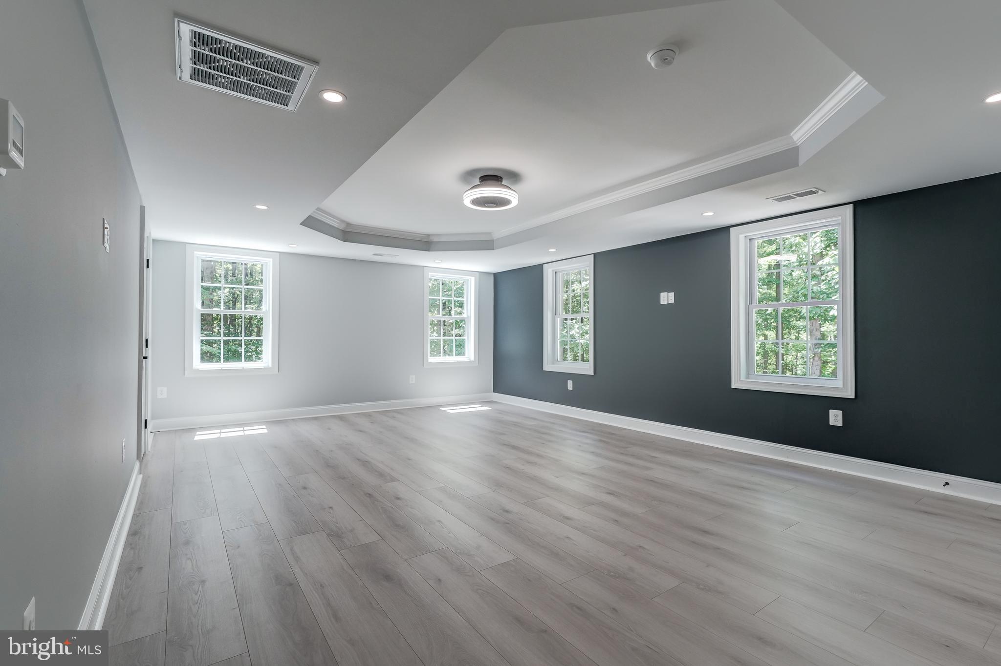 50 Retriever Court Bumpass, VA 23024 - Photo 53 of 77 an empty room with wooden floor and windows