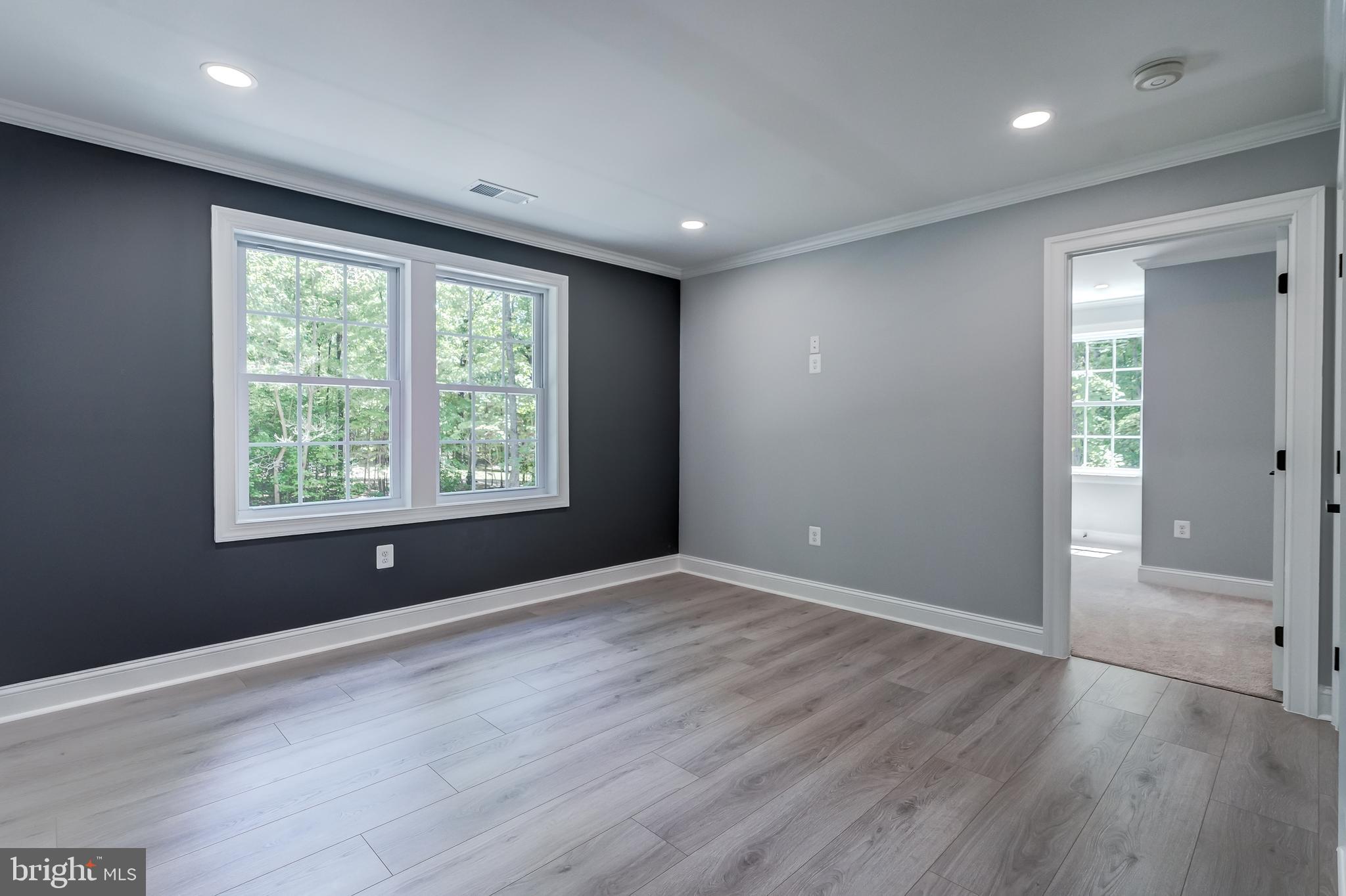 50 Retriever Court Bumpass, VA 23024 - Photo 54 of 77 an empty room with wooden floor and windows