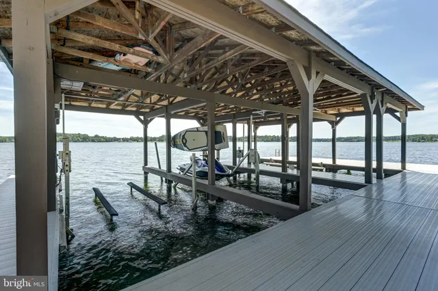 a view of a house with a yard and large tree