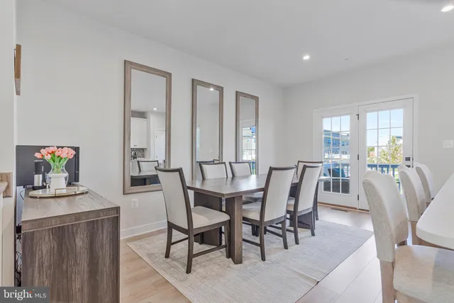 a view of a dining room with furniture and a potted plant