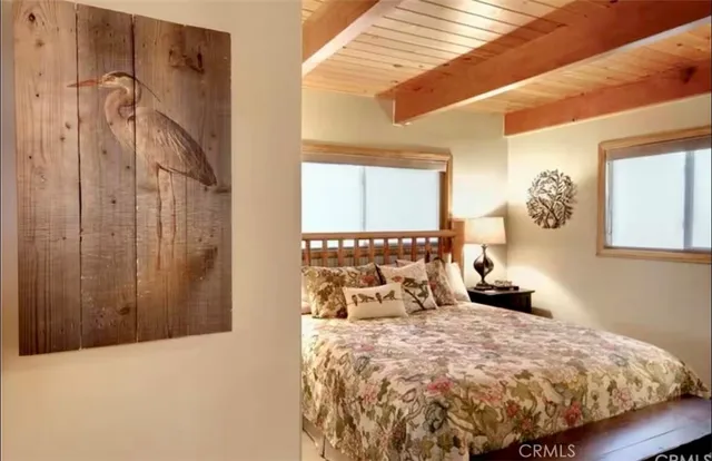 a bedroom with a bed and a mirror