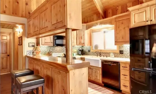 a kitchen with stainless steel appliances granite countertop a stove and cabinets
