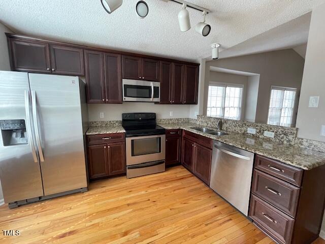 109 Tabula Place Cary, NC 27513 - Photo 12 of 26 a kitchen with stainless steel appliances granite countertop a refrigerator a stove top oven a sink and dishwasher