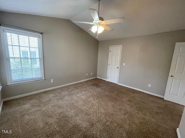 109 Tabula Place Cary, NC 27513 - Photo 13 of 26 an empty room with a chandelier fan and windows