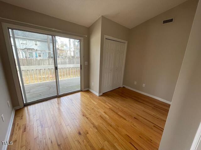 109 Tabula Place Cary, NC 27513 - Photo 18 of 26 a view of an empty room with wooden floor and a window