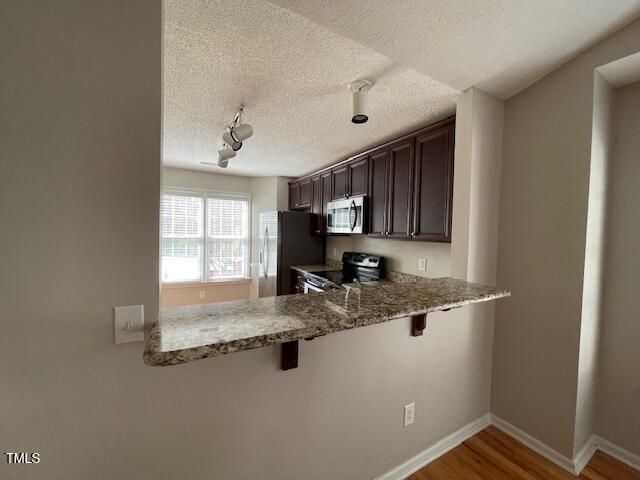 109 Tabula Place Cary, NC 27513 - Photo 6 of 26 a kitchen with stainless steel appliances granite countertop a sink window and cabinets