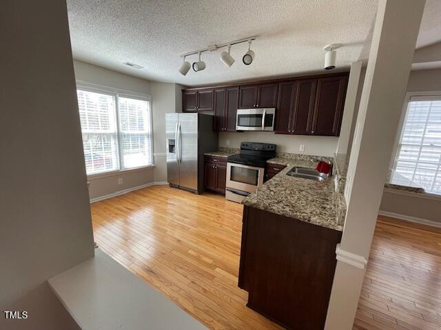 109 Tabula Place Cary, NC 27513 - Photo 8 of 26 a kitchen with stainless steel appliances granite countertop a sink stove and refrigerator