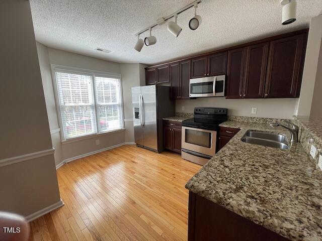 109 Tabula Place Cary, NC 27513 - Photo 10 of 26 a kitchen with stainless steel appliances granite countertop a sink stove microwave and refrigerator