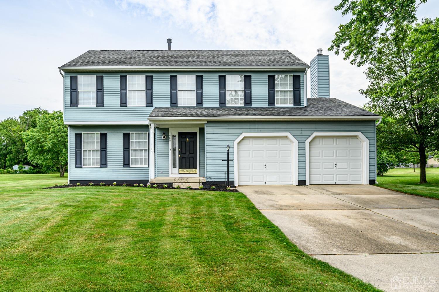 709 Henderson Road Lumberton, NJ 08048 - Photo 1 of 46 a front view of a house with a garden and yard