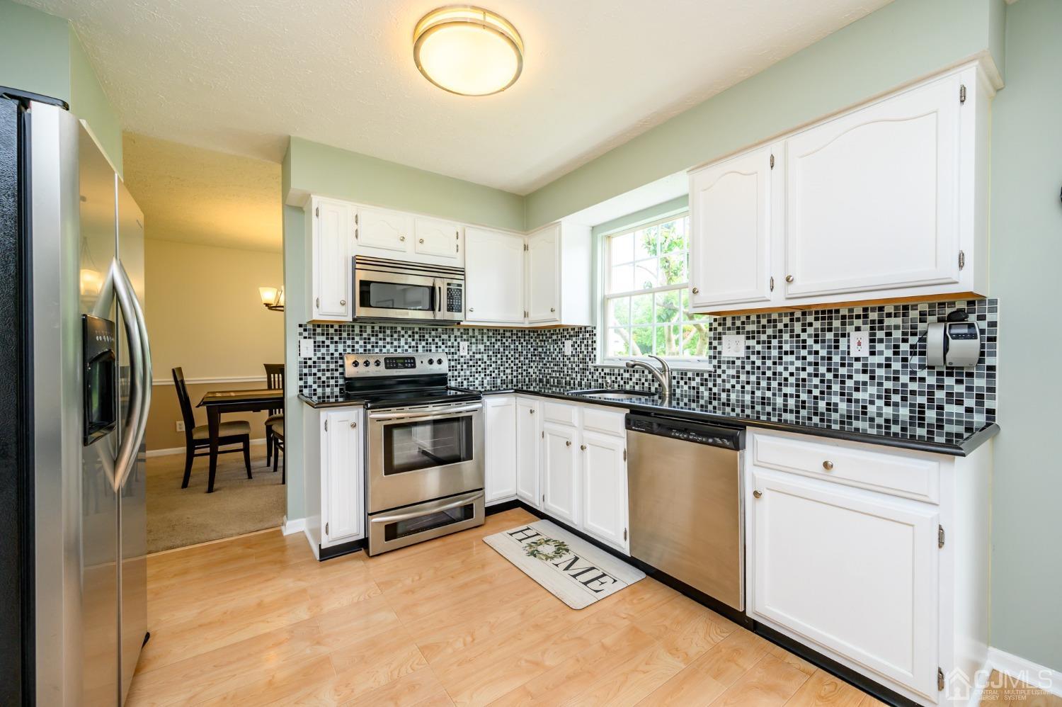709 Henderson Road Lumberton, NJ 08048 - Photo 11 of 46 a kitchen with granite countertop white cabinets and stainless steel appliances