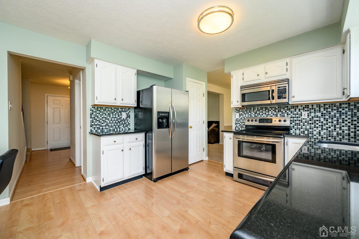 709 Henderson Road Lumberton, NJ 08048 - Photo 12 of 46 a kitchen with stainless steel appliances granite countertop a stove a refrigerator and a stove