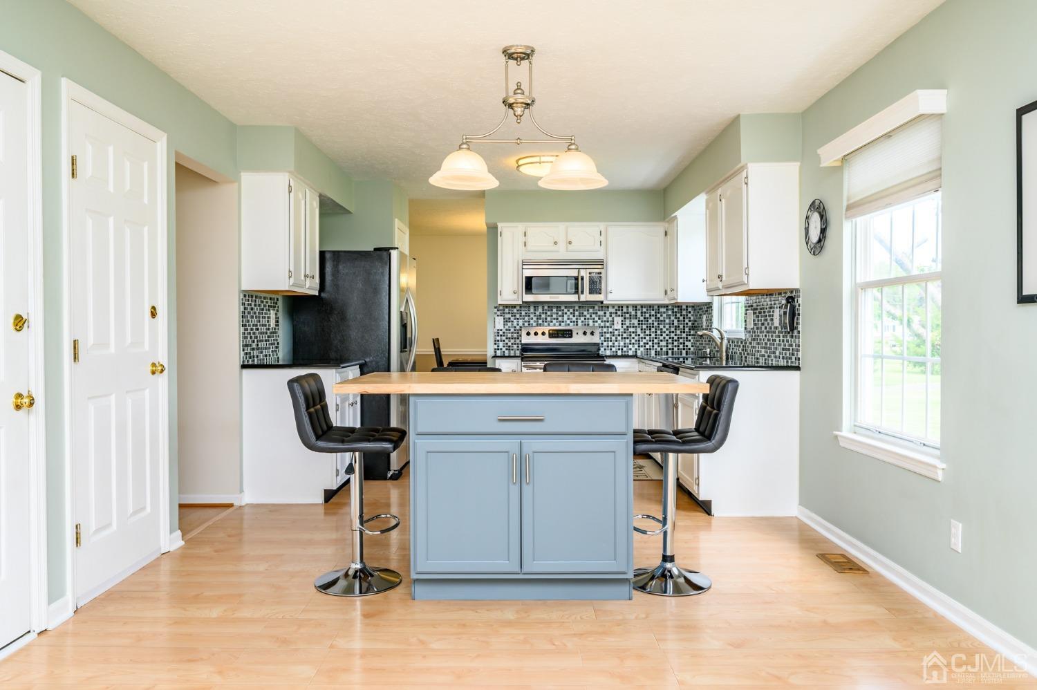 709 Henderson Road Lumberton, NJ 08048 - Photo 14 of 46 a kitchen with kitchen island granite countertop a stove a sink and a refrigerator