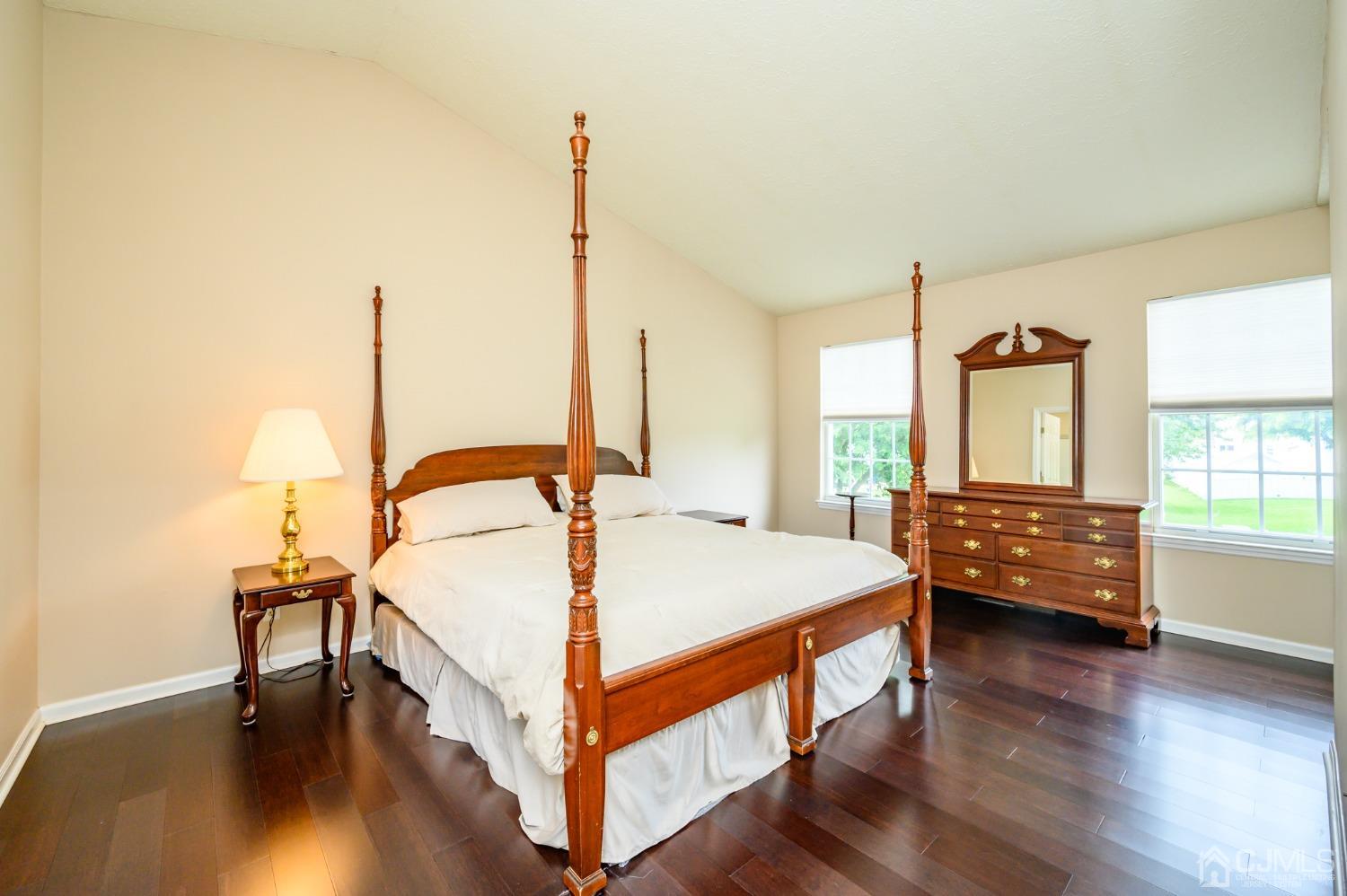 709 Henderson Road Lumberton, NJ 08048 - Photo 29 of 46 a bedroom with a bed a table and wooden floor