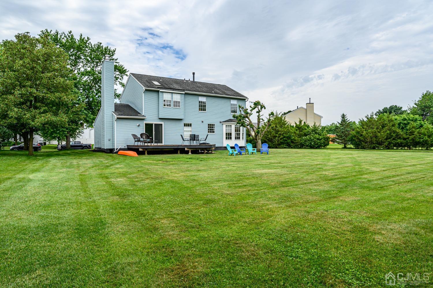 709 Henderson Road Lumberton, NJ 08048 - Photo 45 of 46 a view of a white house in front of a big yard with plants and large trees