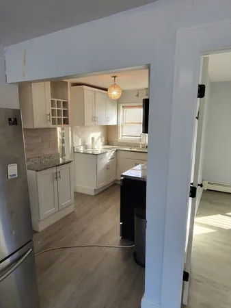 a kitchen with a sink refrigerator and cabinets