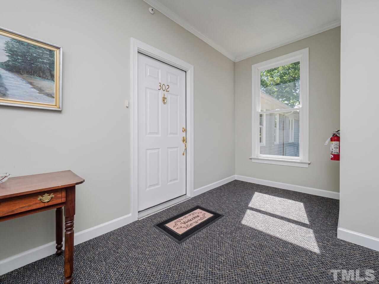 3701 Holly Lane, Unit 302 Raleigh, NC 27612 - Photo 2 of 30 Entrance to unit from hallway with elevator and stairs.