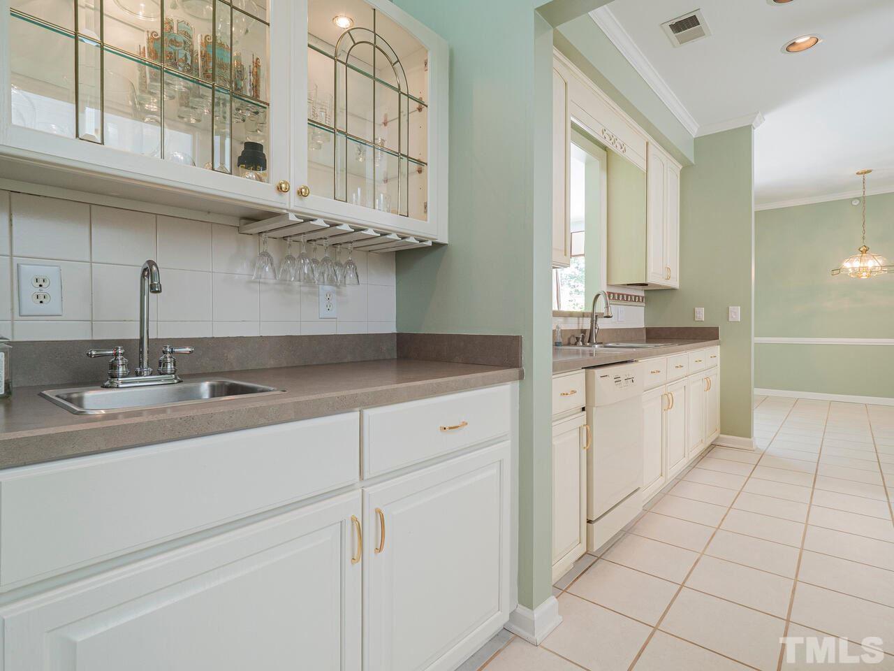3701 Holly Lane, Unit 302 Raleigh, NC 27612 - Photo 9 of 30 Wet bar between dining room and kitchen and across from walk-in pantry.