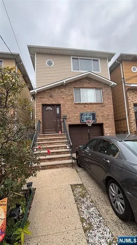 a front view of a house with parking space