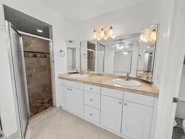 a bathroom with a double vanity sink and a mirror