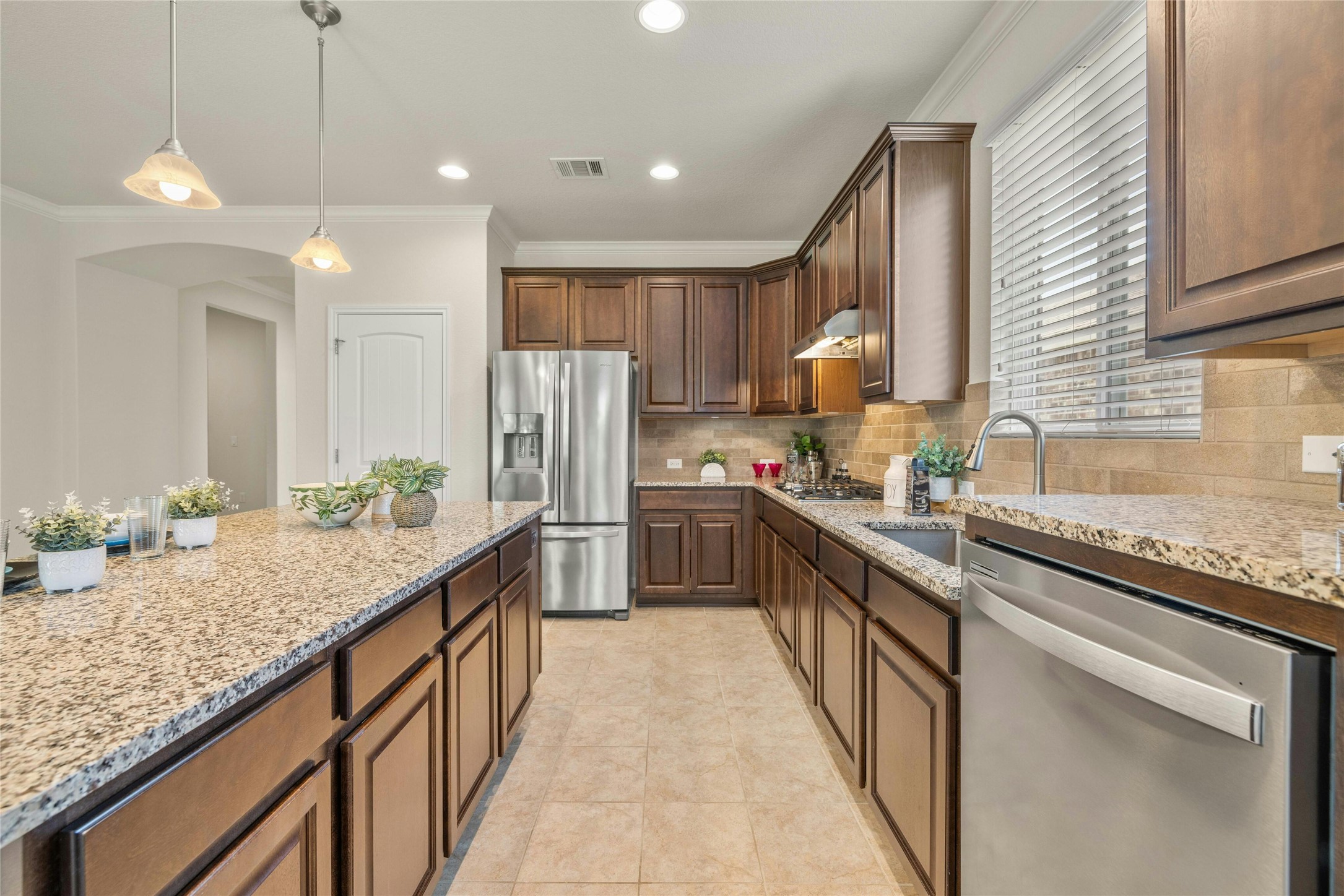203 Longview Lane Georgetown, TX 78633 - Photo 11 of 37 a kitchen with granite countertop kitchen island stainless steel appliances a sink stove and refrigerator