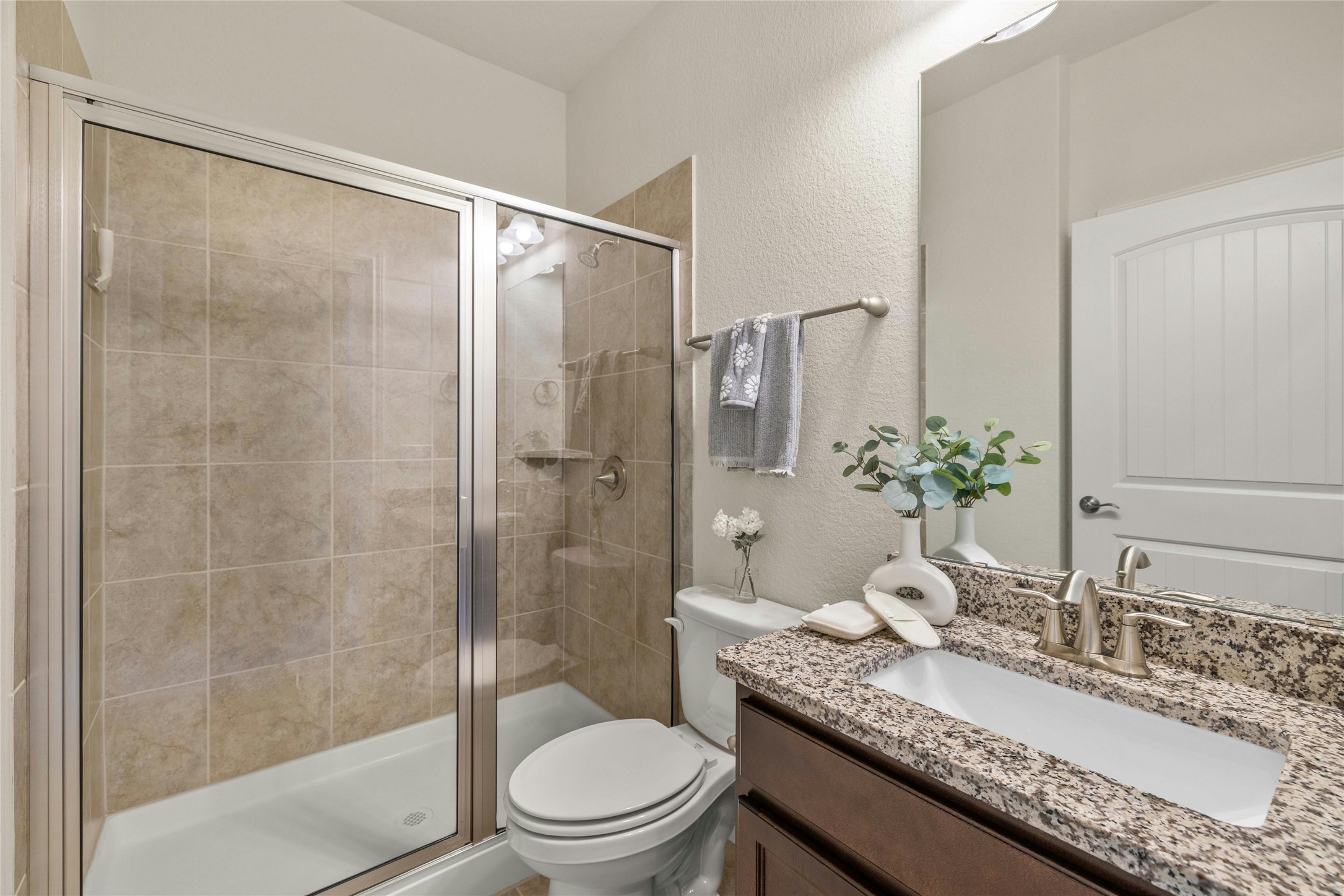 203 Longview Lane Georgetown, TX 78633 - Photo 30 of 37 a bathroom with a granite countertop sink a toilet and shower