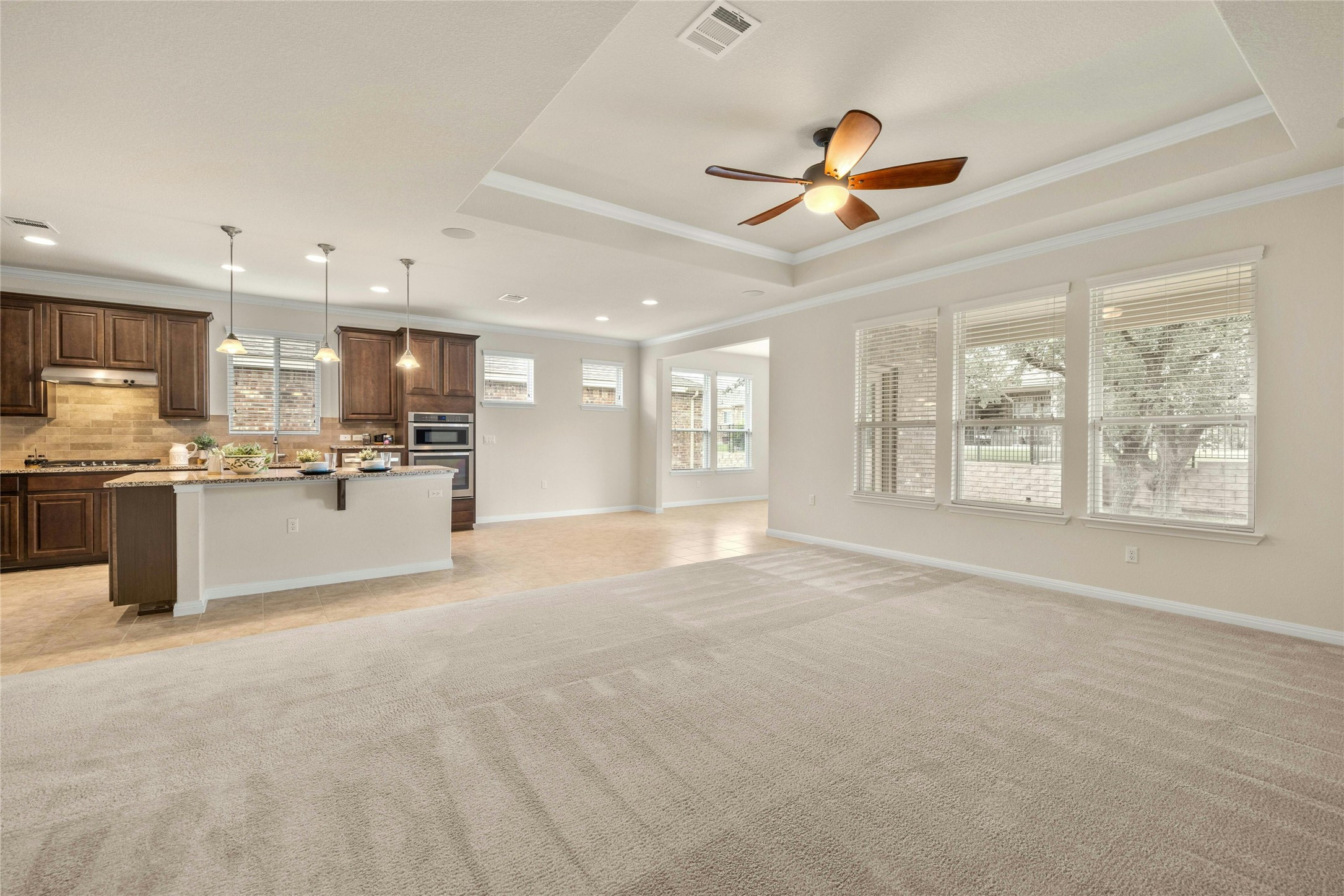 203 Longview Lane Georgetown, TX 78633 - Photo 8 of 37 a living room with stainless steel appliances kitchen island granite countertop a refrigerator a stove top oven a sink with island and chairs