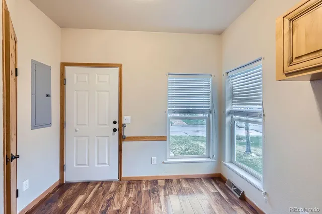 a view of front door with wooden floor