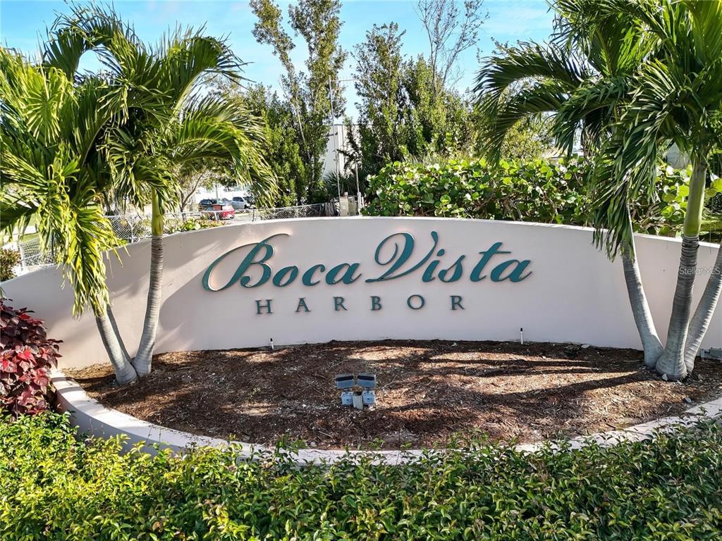 13113 Gasparilla Road, Unit 403 Placida, FL 33946 - Photo 62 of 62 a sign that is on a brick wall with plants