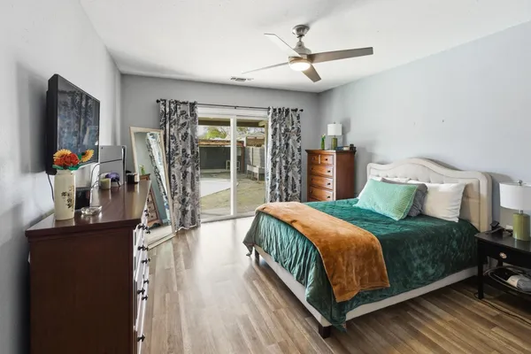 a bedroom with a bed and wooden floor