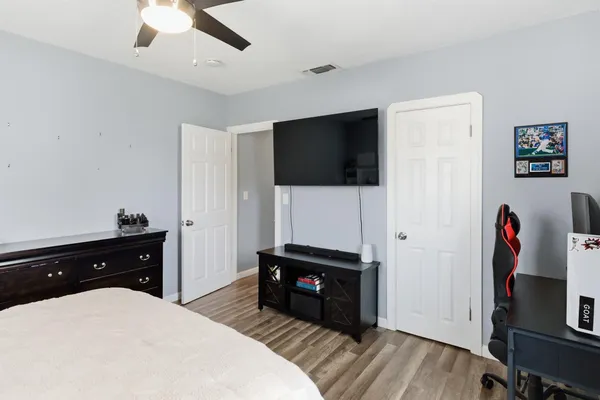 a bedroom with a bed and a flat screen tv