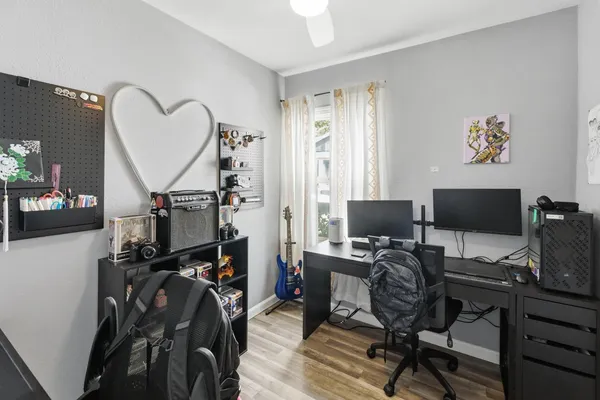 a view of a workspace with furniture and a window