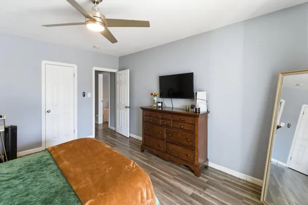 a bedroom with a bed and a flat screen tv