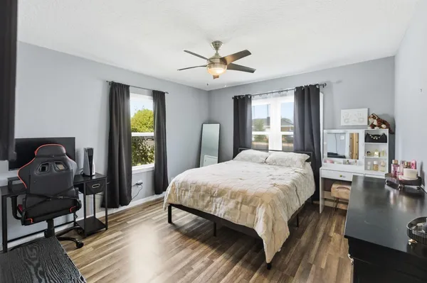 a bedroom with a bed window and a table