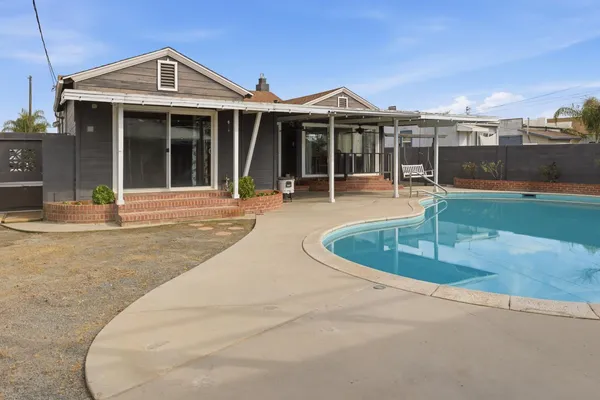 a view of a house with swimming pool and porch