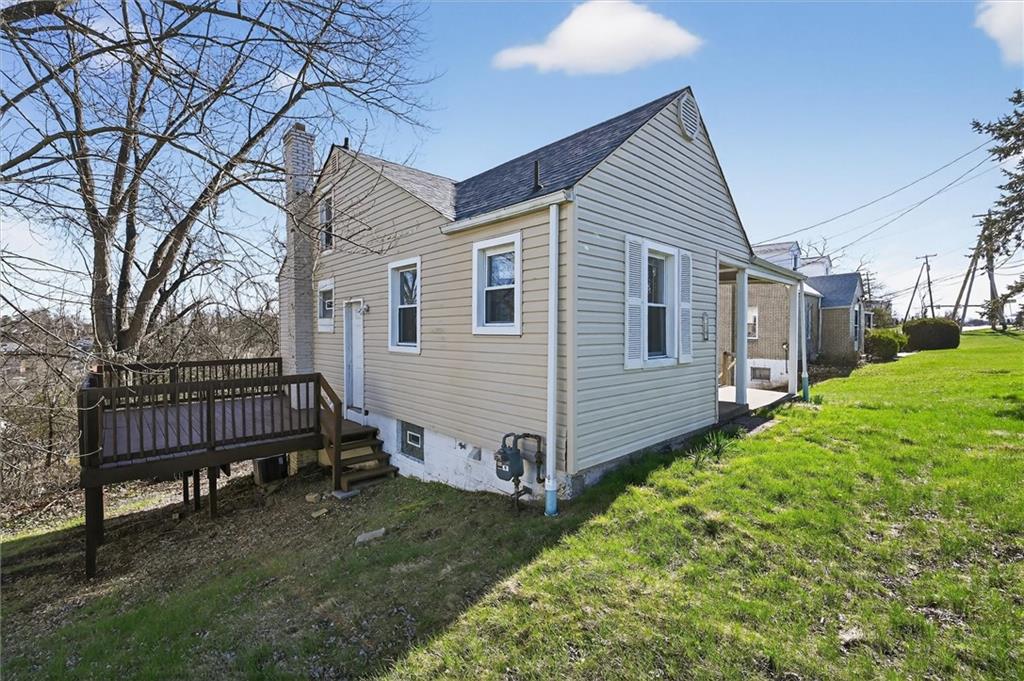 a view of a house with a yard and wooden fence