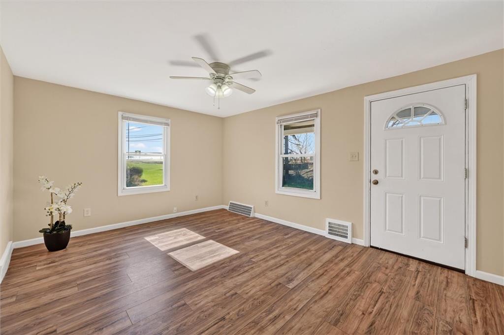 314 Fort Couch Road Pittsburgh, PA 15241 - Photo 4 of 26 a view of empty room with wooden floor and window