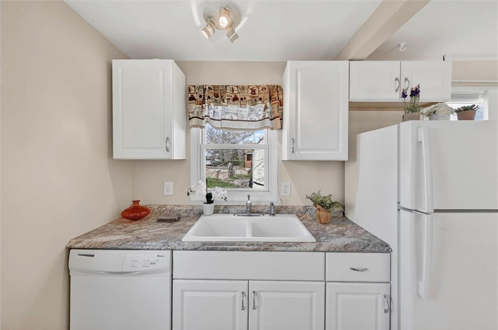 314 Fort Couch Road Pittsburgh, PA 15241 - Photo 9 of 26 a kitchen with stainless steel appliances granite countertop a refrigerator sink and white cabinets