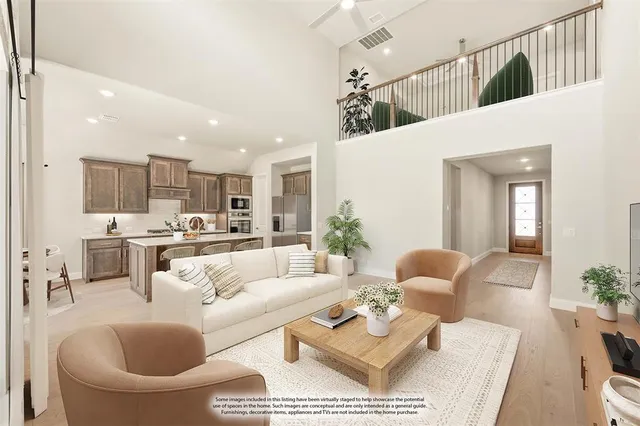 a living room with furniture kitchen view and a chandelier