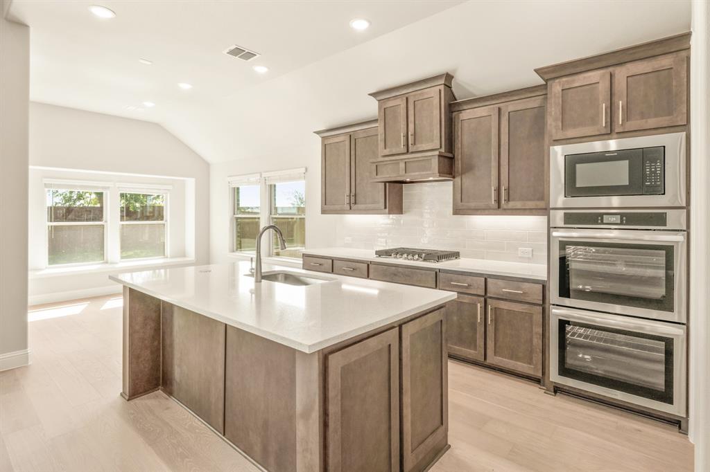 1098 Foxtail Drive Justin, TX 76247 - Photo 14 of 40 a kitchen with a sink stove and refrigerator
