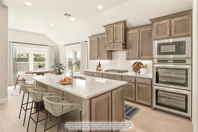 a kitchen with a sink appliances and cabinets