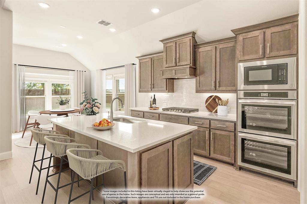 1098 Foxtail Drive Justin, TX 76247 - Photo 15 of 40 a kitchen with a sink appliances and cabinets
