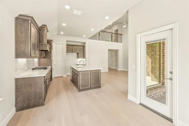 a view of kitchen with stainless steel appliances kitchen island a sink stove and refrigerator