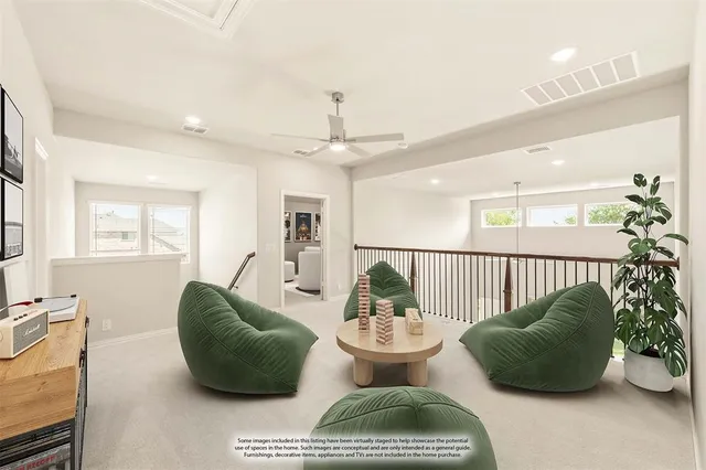 a living room with furniture potted plant and windows