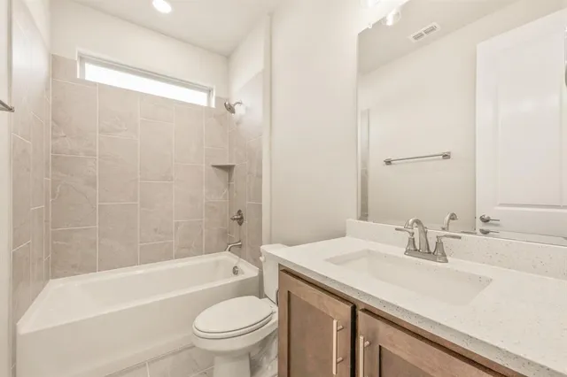 a bathroom with a sink a toilet and a bathtub