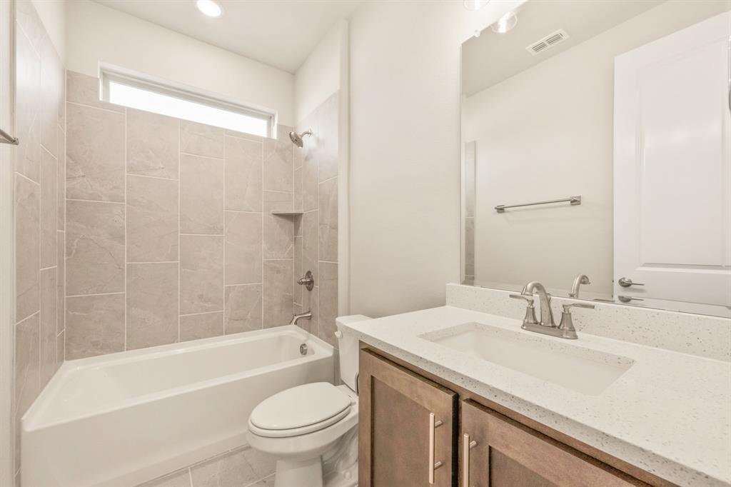 1098 Foxtail Drive Justin, TX 76247 - Photo 8 of 40 a bathroom with a sink a toilet and a bathtub