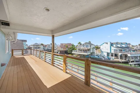 a view of a balcony with wooden floor and outdoor space