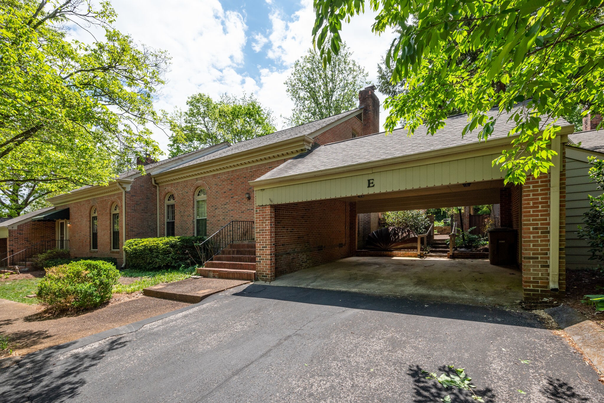 3704 Estes Road, Unit E Nashville, TN 37215 - Photo 21 of 27 a front view of a house with a yard and garage